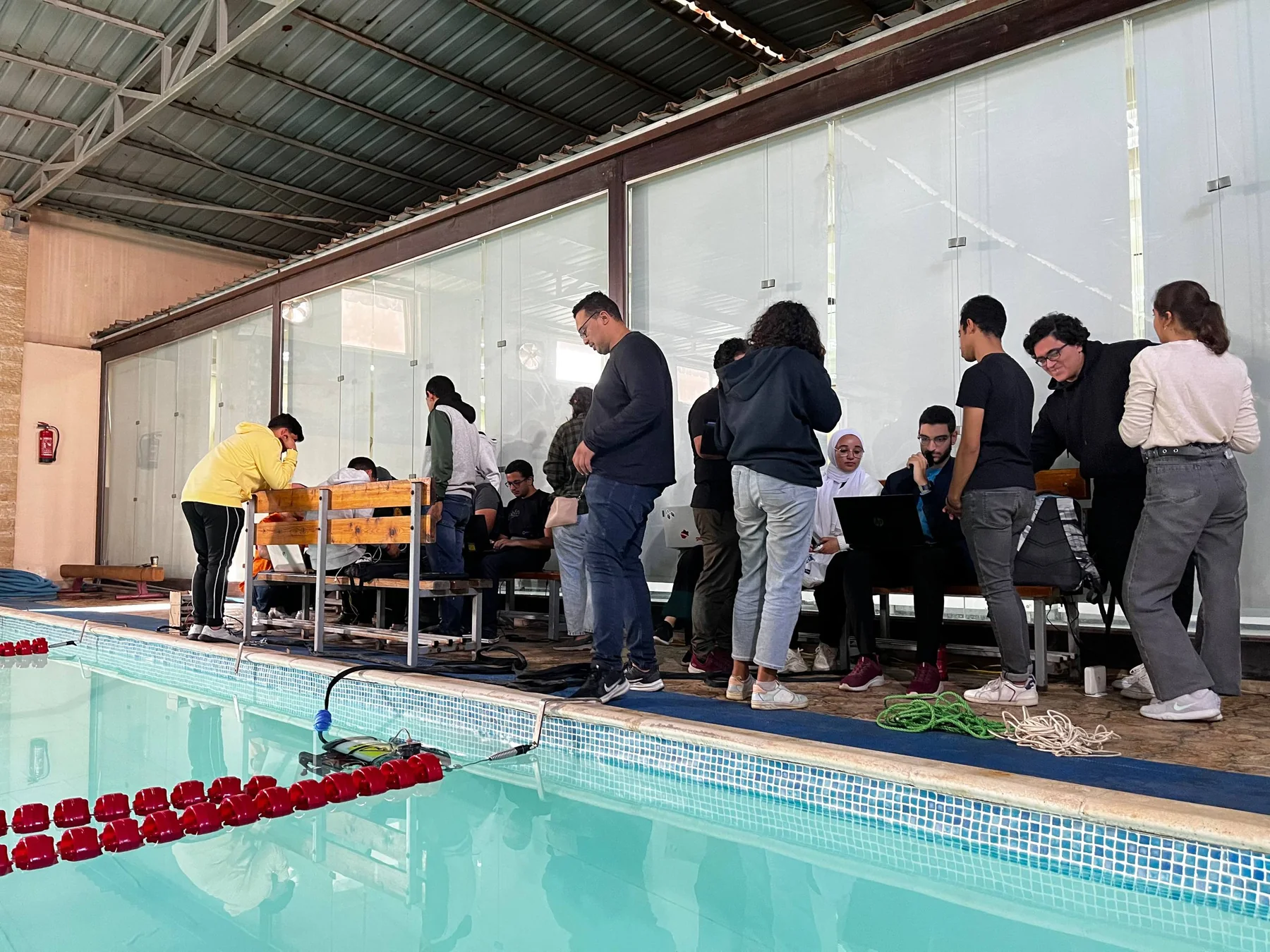 RobEn team operating and testing underwater robot by the pool